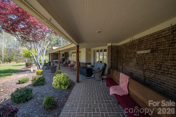 a view of a patio with chairs and potted plants
