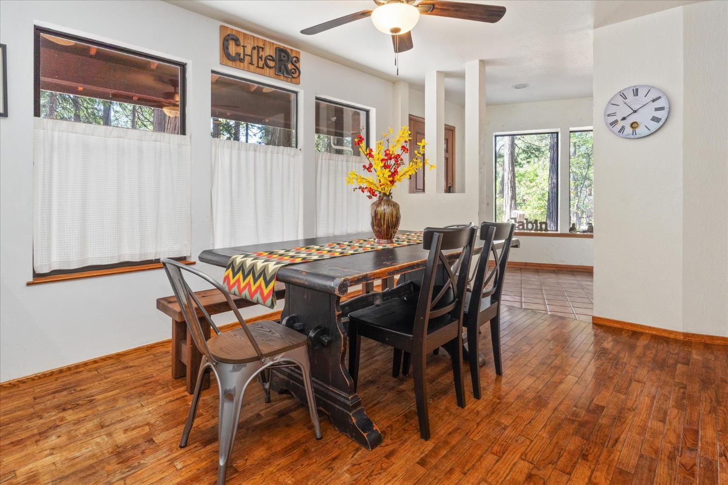 680 Larkspur Lane Murphys, CA 95247 - Photo 12 of 41 a view of a dining room with furniture a chandelier and wooden floor
