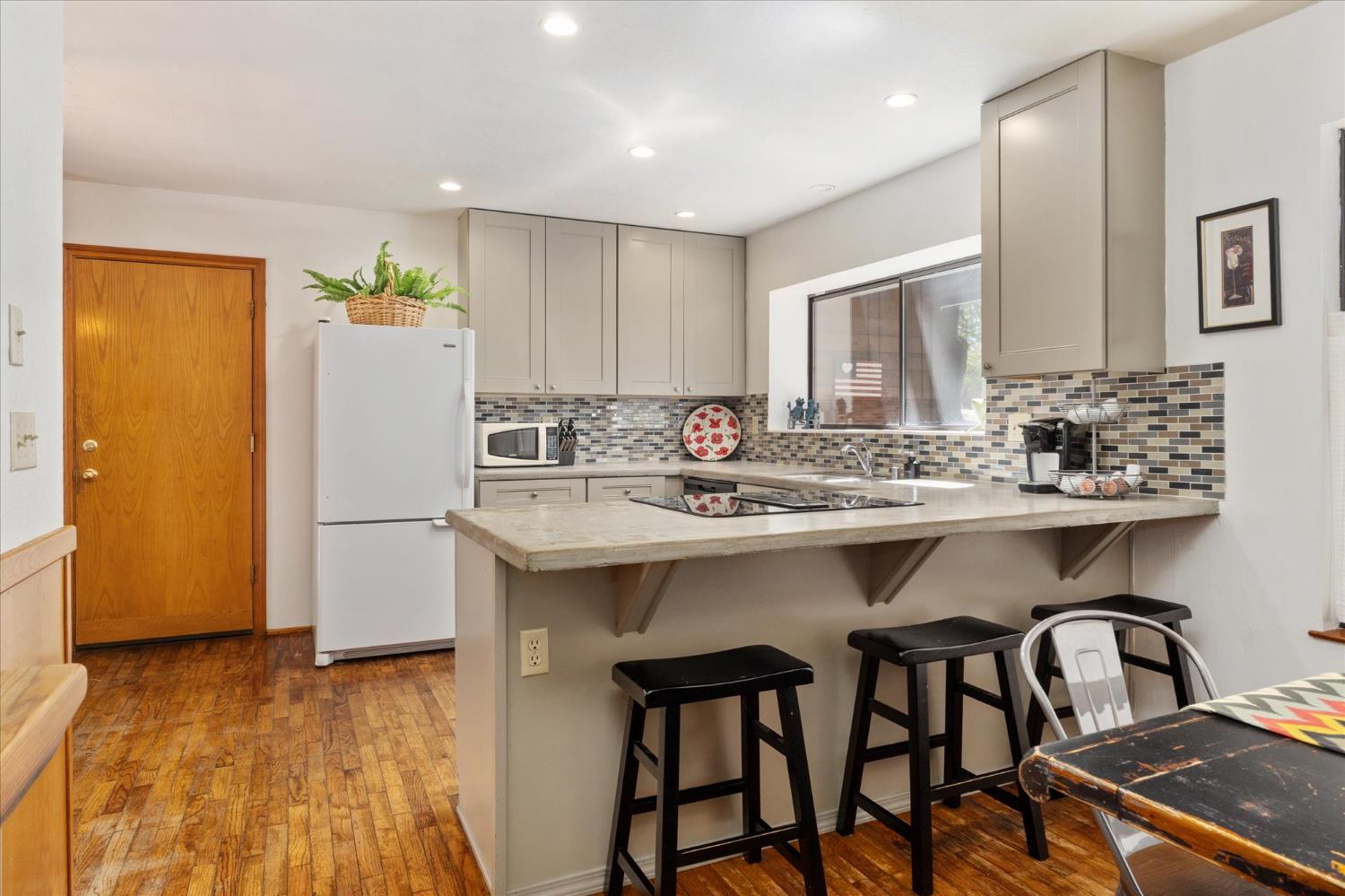 680 Larkspur Lane Murphys, CA 95247 - Photo 13 of 41 a kitchen with a sink cabinets and wooden floor