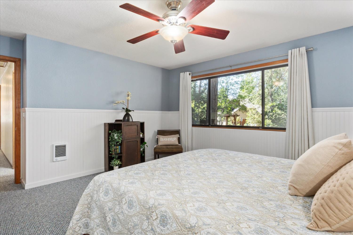 680 Larkspur Lane Murphys, CA 95247 - Photo 19 of 41 a bedroom with a large bed and a chandelier
