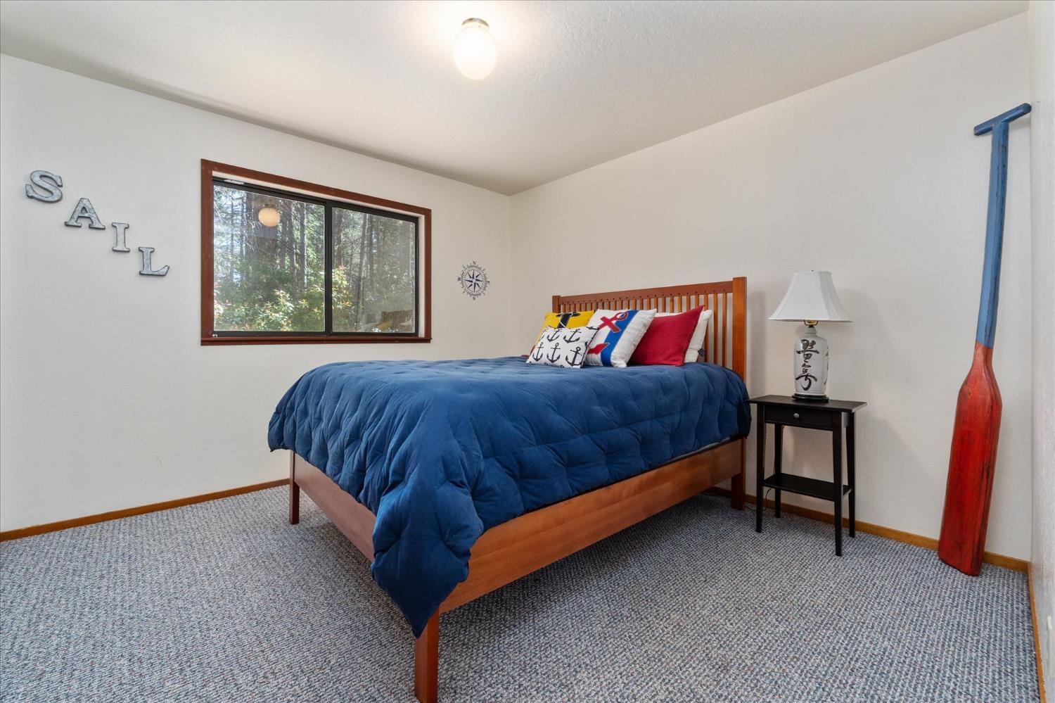 680 Larkspur Lane Murphys, CA 95247 - Photo 23 of 41 a bedroom with a bed and a painting on the wall