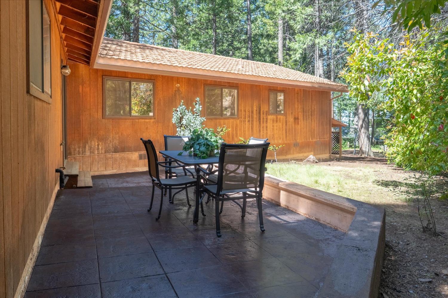 680 Larkspur Lane Murphys, CA 95247 - Photo 27 of 41 a view of a patio with table and chairs and potted plants