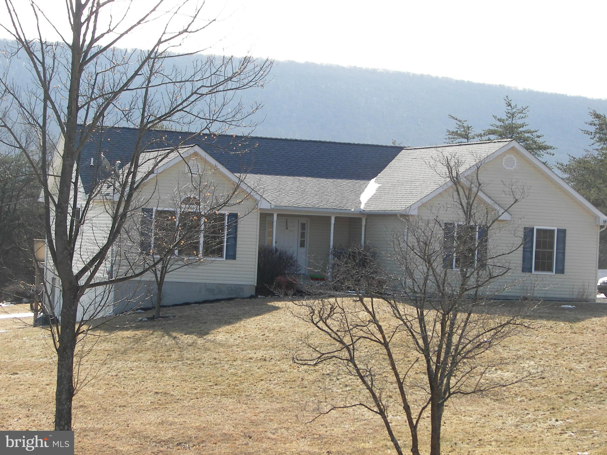 3619 Highland Ridge Road Berkeley Springs, WV 25411 - Photo 1 of 30 a view of a house with a yard covered in snow