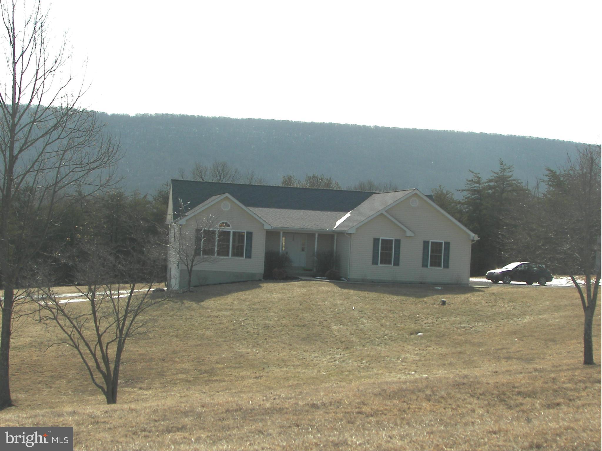 3619 Highland Ridge Road Berkeley Springs, WV 25411 - Photo 2 of 30 a front view of a house with a yard