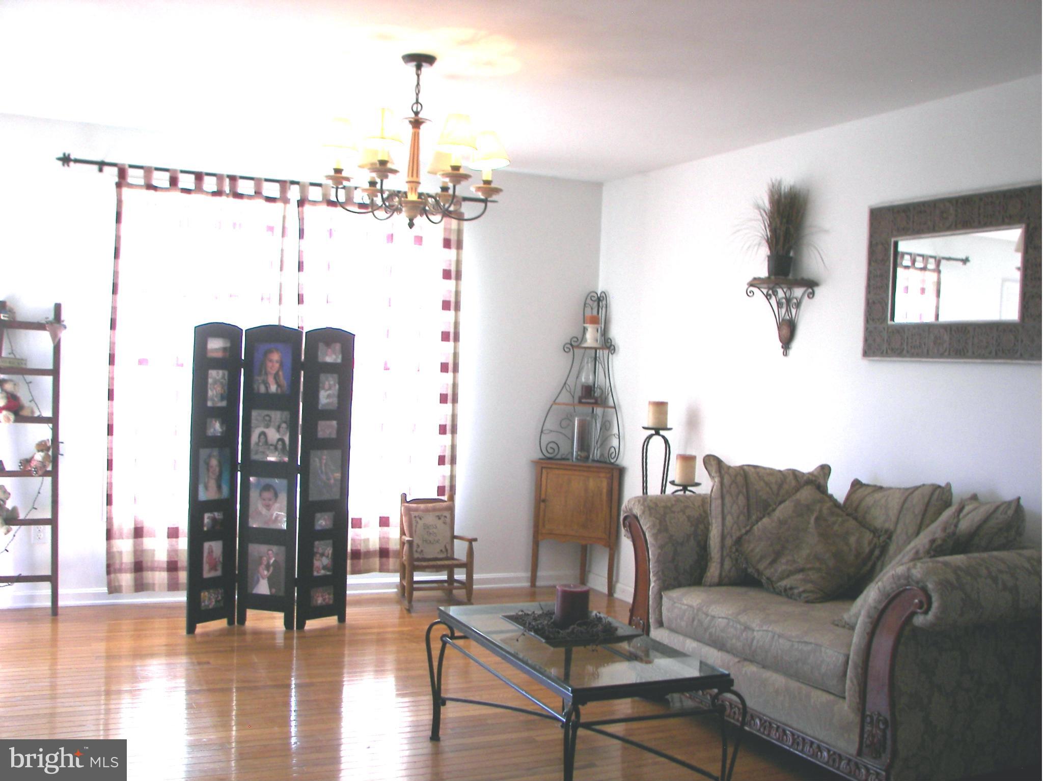 3619 Highland Ridge Road Berkeley Springs, WV 25411 - Photo 14 of 30 a living room with furniture and a chandelier