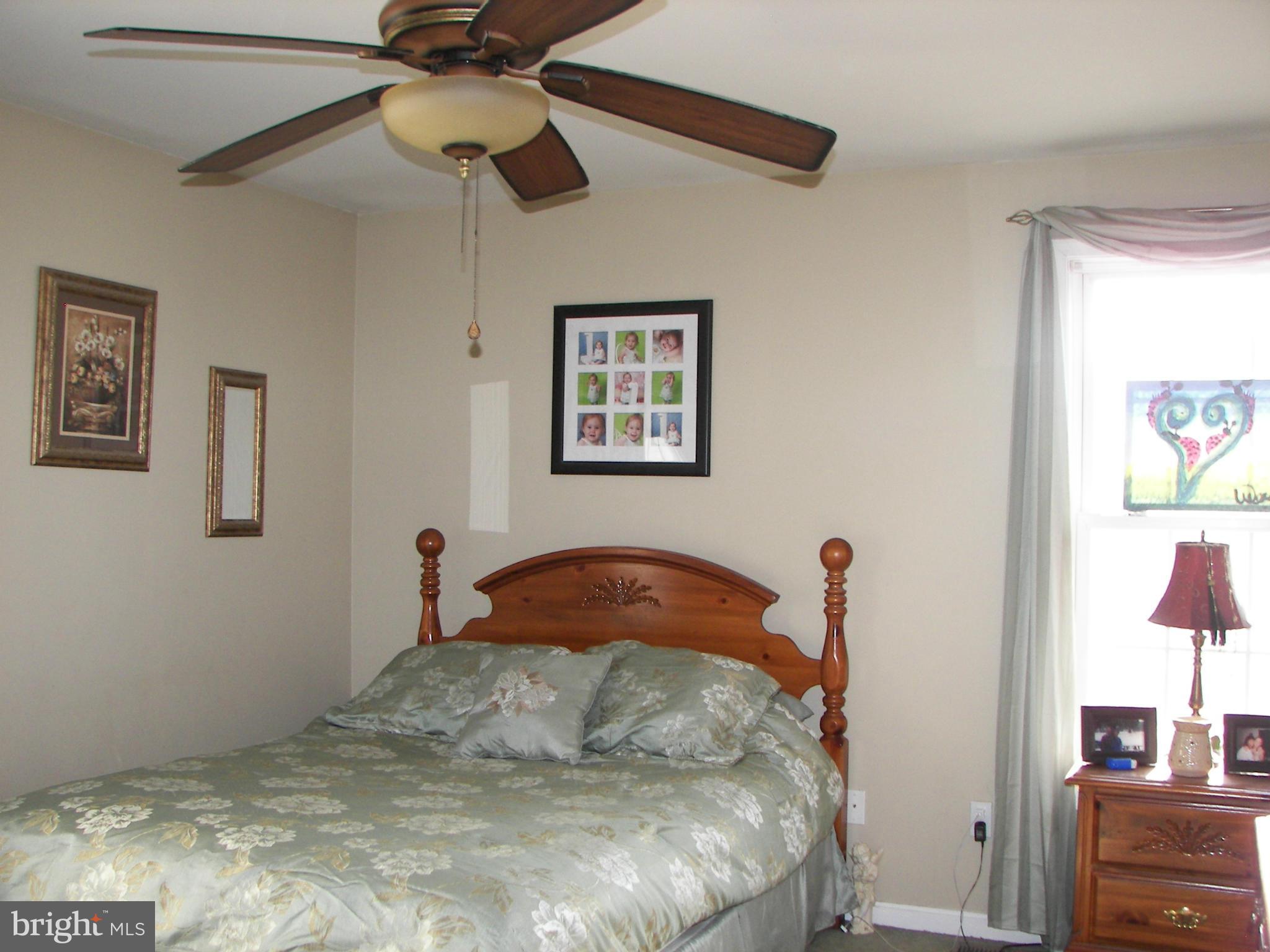 3619 Highland Ridge Road Berkeley Springs, WV 25411 - Photo 16 of 30 a bedroom with a bed and a chandelier