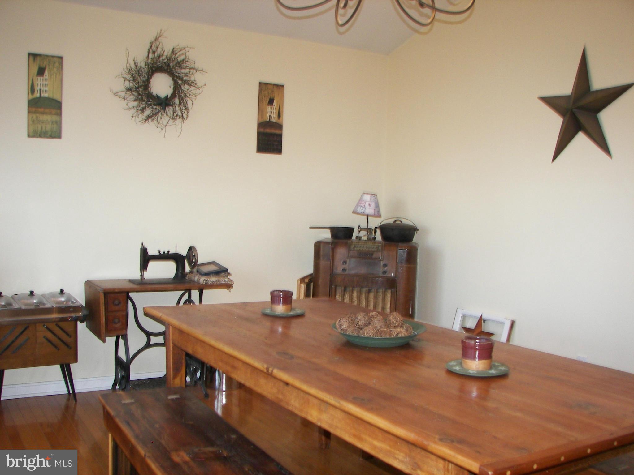 3619 Highland Ridge Road Berkeley Springs, WV 25411 - Photo 6 of 30 a view of a dining room with furniture and wooden floor
