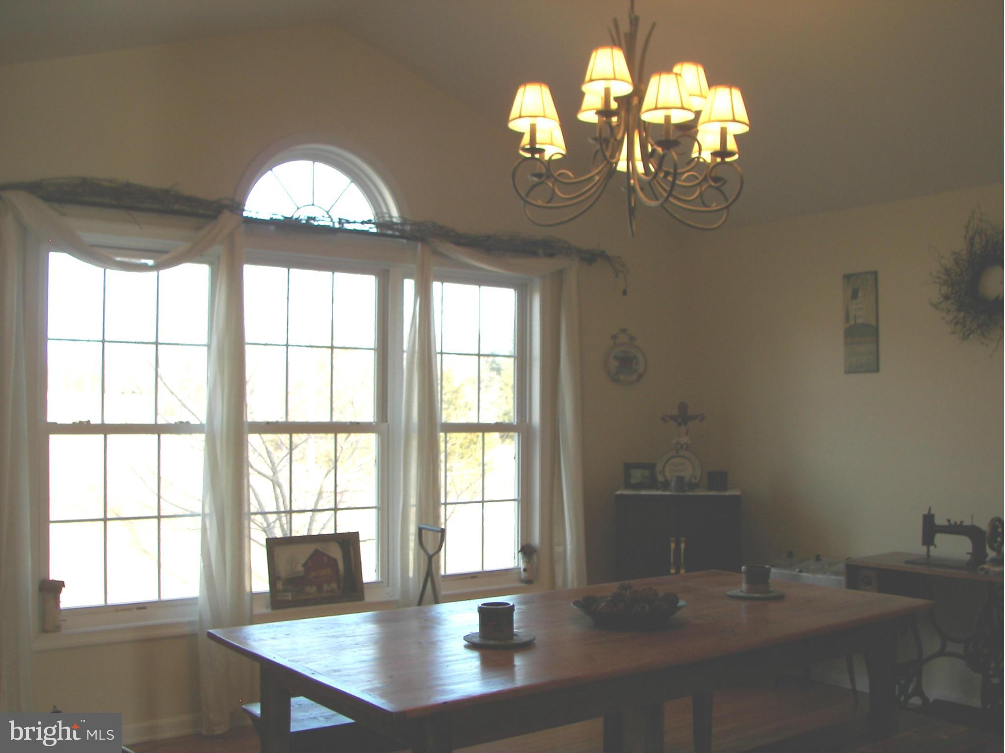 3619 Highland Ridge Road Berkeley Springs, WV 25411 - Photo 7 of 30 a view of a room with wooden floor chandelier and windows