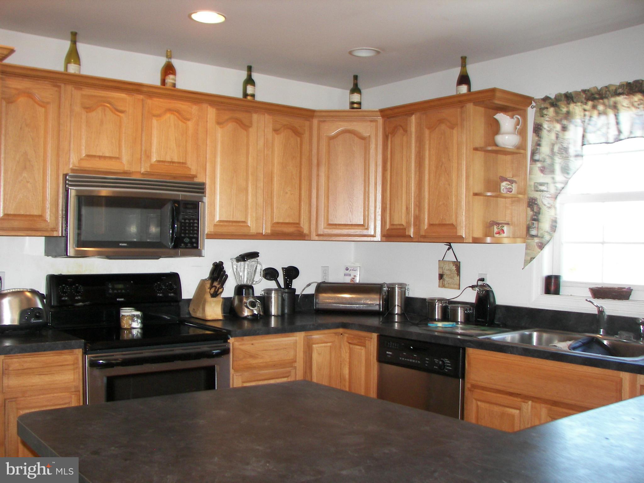 3619 Highland Ridge Road Berkeley Springs, WV 25411 - Photo 8 of 30 a kitchen with granite countertop a stove a sink and a granite counter tops