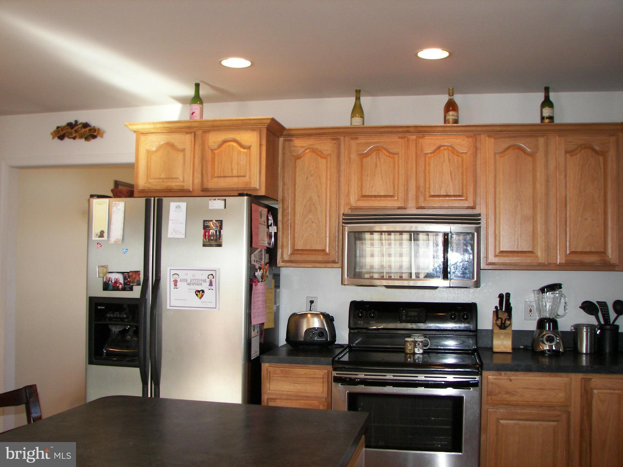 3619 Highland Ridge Road Berkeley Springs, WV 25411 - Photo 9 of 30 a kitchen with stainless steel appliances granite countertop a refrigerator and a stove top oven