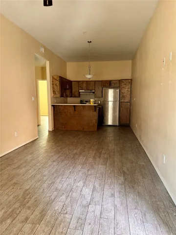 a view of a kitchen with a sink and a refrigerator