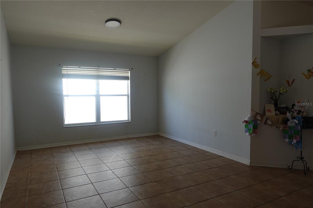 945 Tramells Trail Kissimmee, FL 34744 - Photo 20 of 36 an empty room with windows