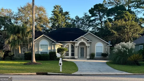 a front view of a house with a yard