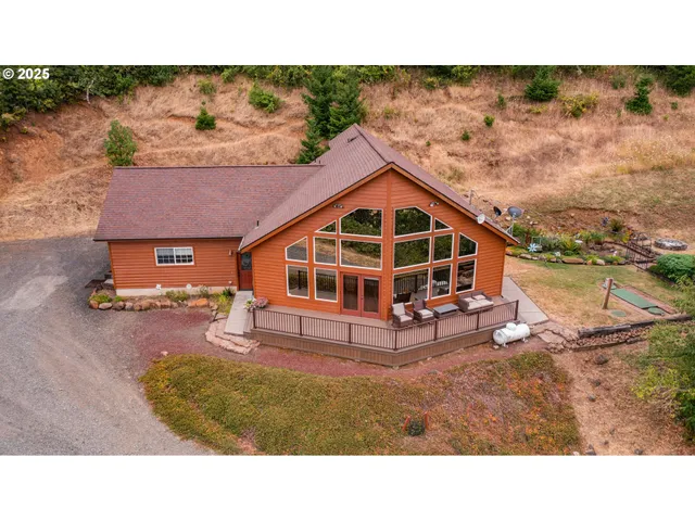 a view of a house with backyard porch and sitting area
