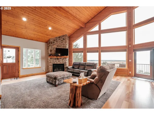 a living room with furniture a flat screen tv and a large window