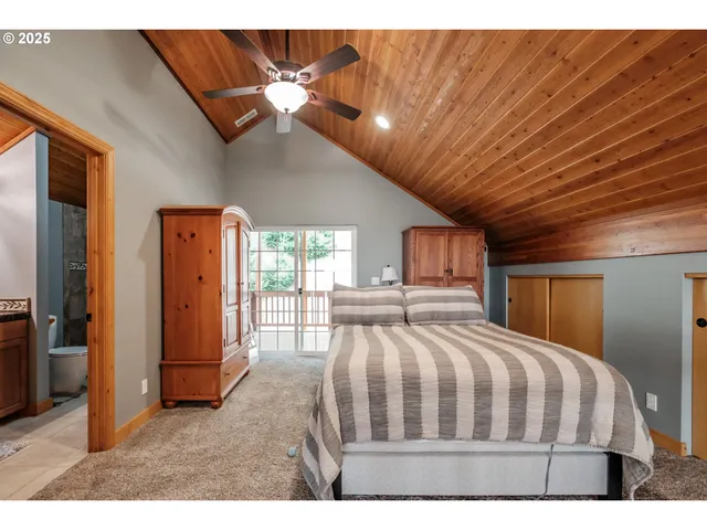 a bedroom with a large bed and a chandelier