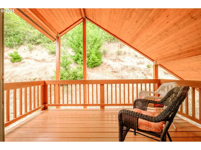 a balcony with wooden floor outdoor seating and city view