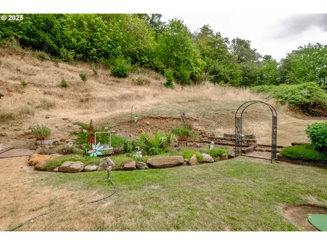 a backyard of a house with table and chairs