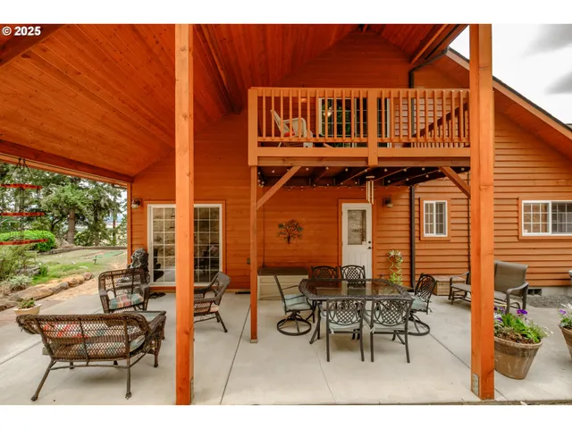 a view of a patio with table and chairs and potted plants