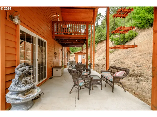 a view of a patio with table and chairs and potted plants