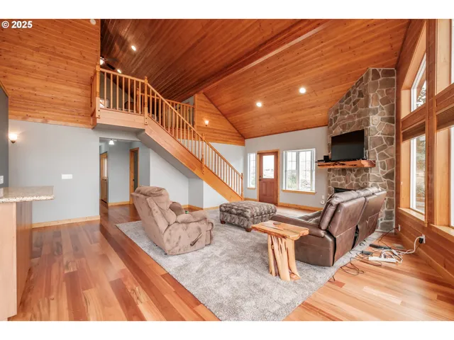 a view of living room kitchen with furniture and fireplace