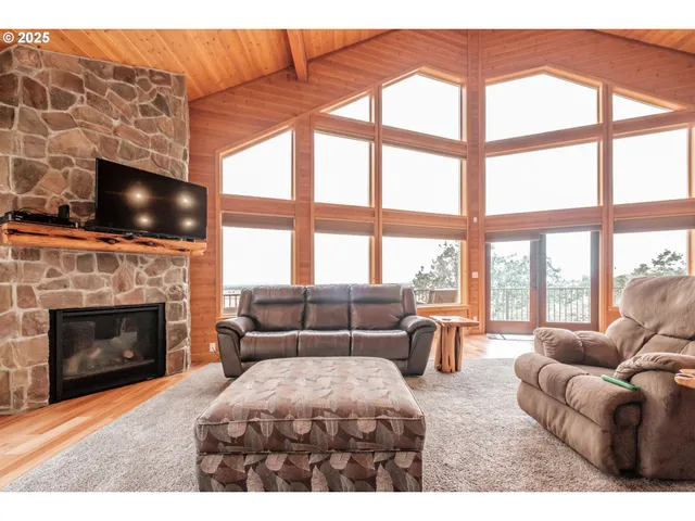 a living room with furniture a fireplace and flat screen tv