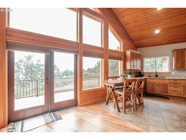 a dining room with furniture a chandelier and wooden floor
