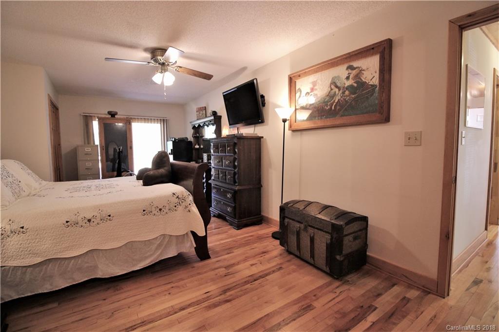 1775 Ebenezer Road Smyrna, SC 29743 - Photo 14 of 36 a spacious bedroom with a bed and a flat screen tv