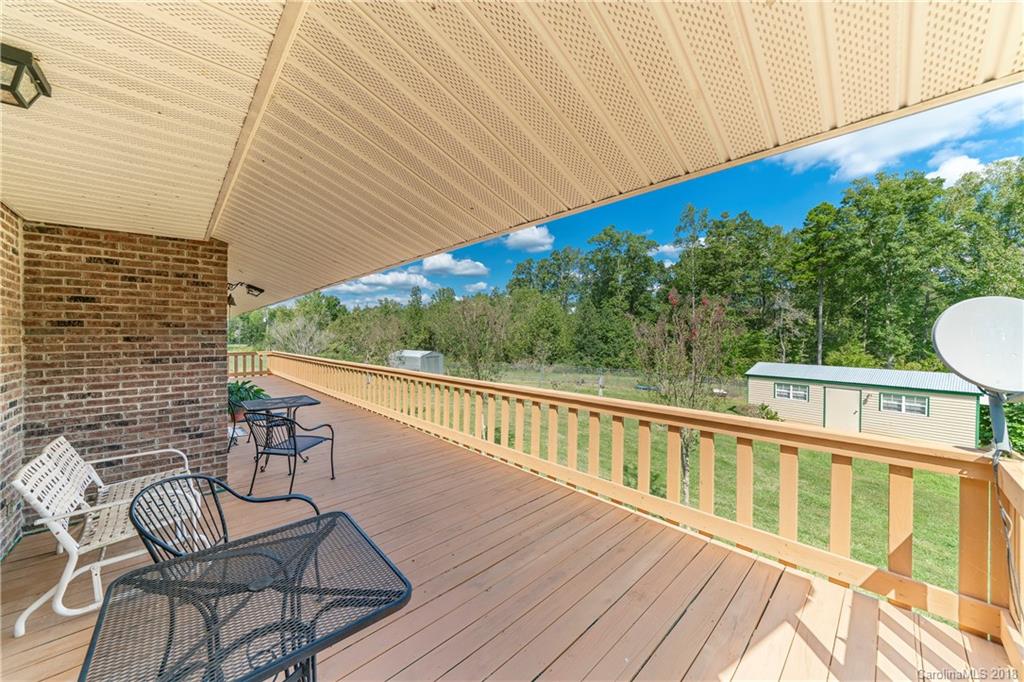 1775 Ebenezer Road Smyrna, SC 29743 - Photo 4 of 36 a view of a balcony with wooden floor and outdoor seating