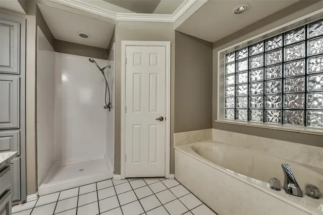 a bathroom with a bathtub and next to a window