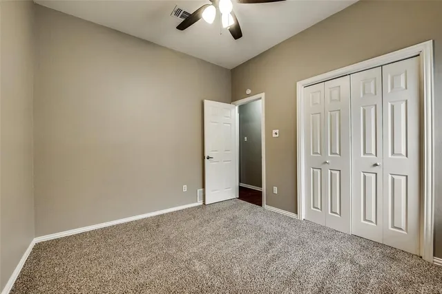an empty room with a ceiling fan