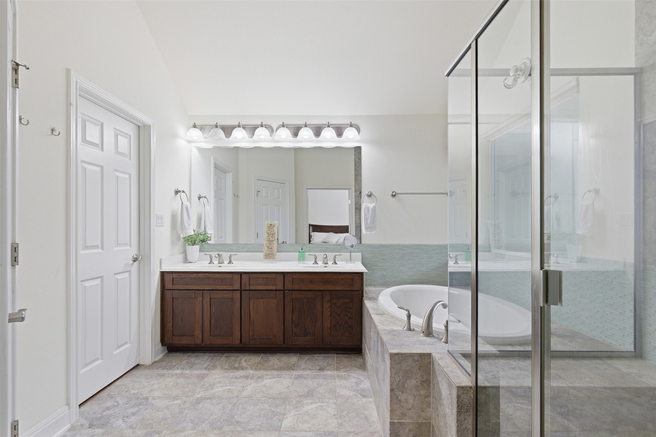 15331 Origins Lane Austin, TX 78734 - Photo 18 of 30 a bathroom with a tub a sink and mirror