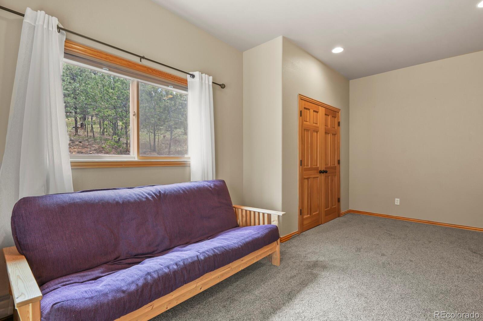417 Witter Gulch Road Evergreen, CO 80439 - Photo 39 of 50 a living room with furniture and a window