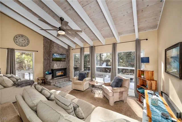 a living room with furniture and a floor to ceiling window