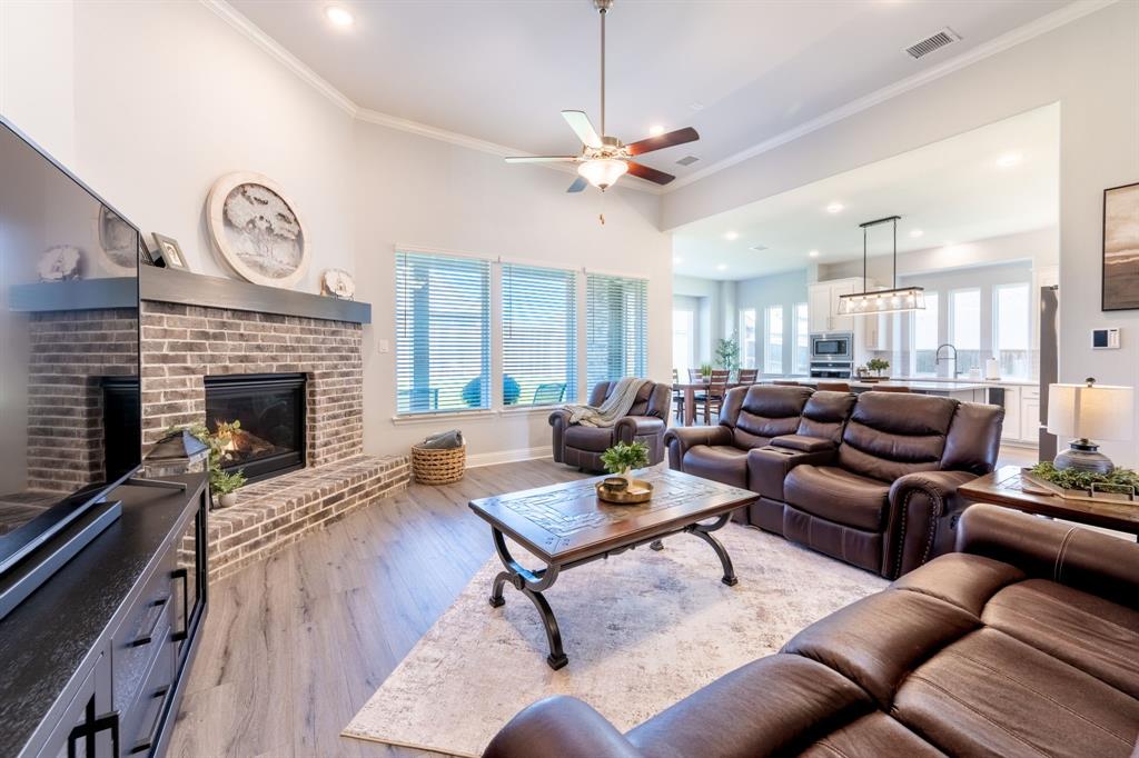 1316 Kirkwood Road Rockwall, TX 75087 - Photo 12 of 37 a living room with furniture a clock and a fireplace