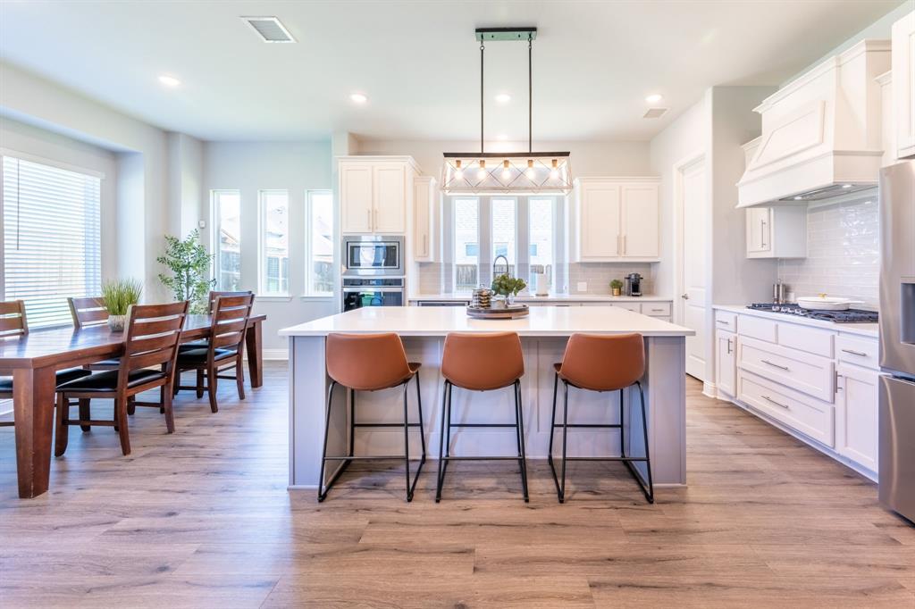 1316 Kirkwood Road Rockwall, TX 75087 - Photo 13 of 37 a large kitchen with a table and chairs