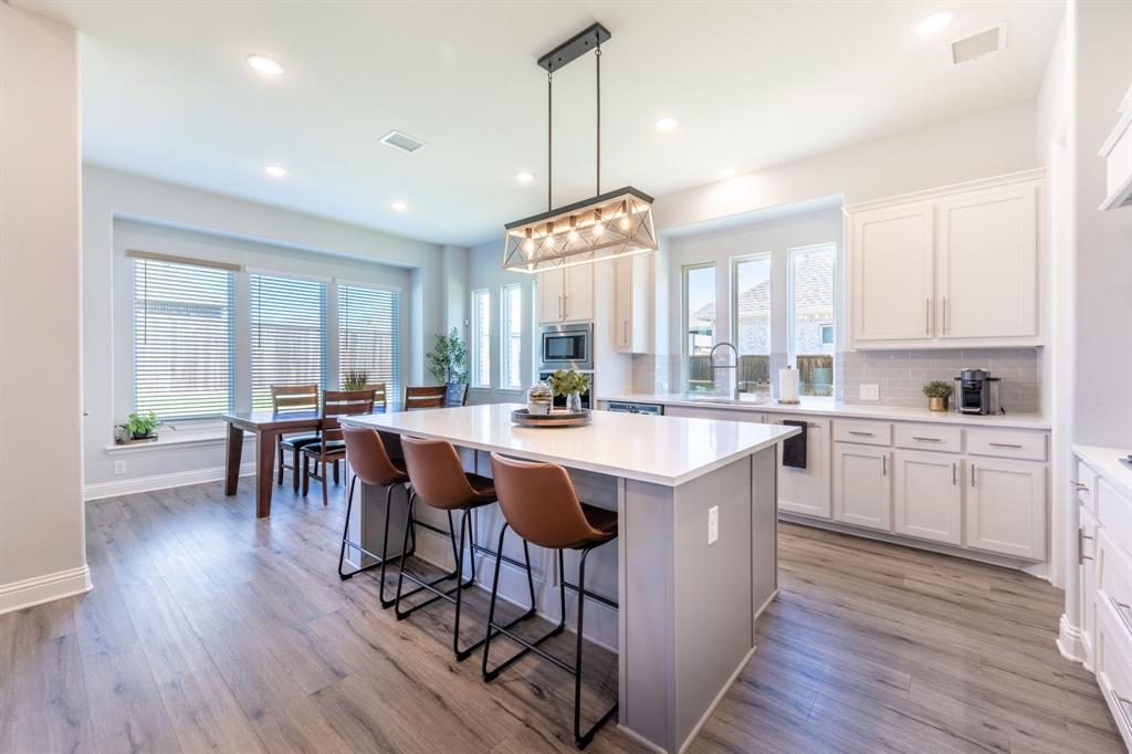 1316 Kirkwood Road Rockwall, TX 75087 - Photo 15 of 37 a kitchen with stainless steel appliances granite countertop a stove a sink a center island and a center island