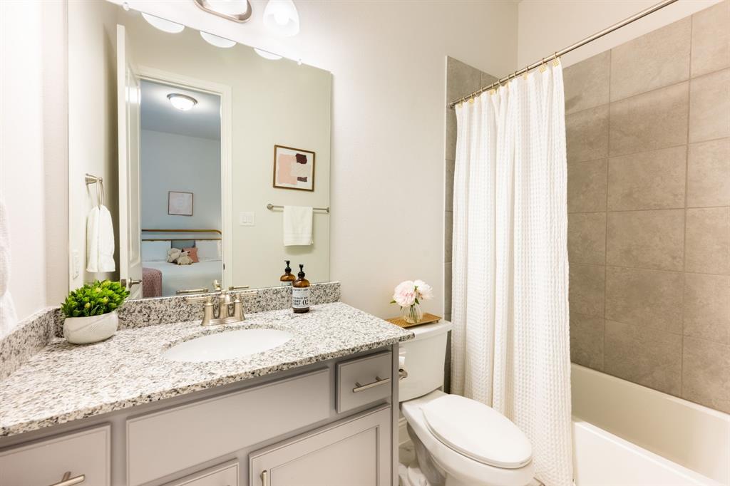 1316 Kirkwood Road Rockwall, TX 75087 - Photo 24 of 37 a bathroom with a granite countertop sink and a mirror