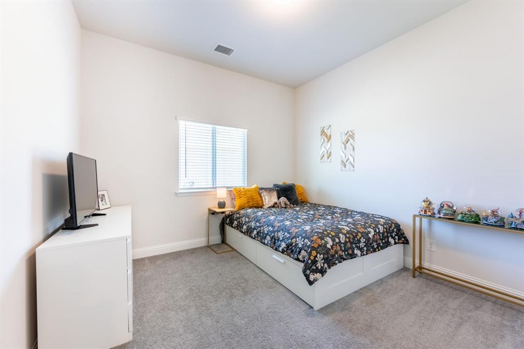 1316 Kirkwood Road Rockwall, TX 75087 - Photo 25 of 37 a bedroom with a bed and flat screen tv