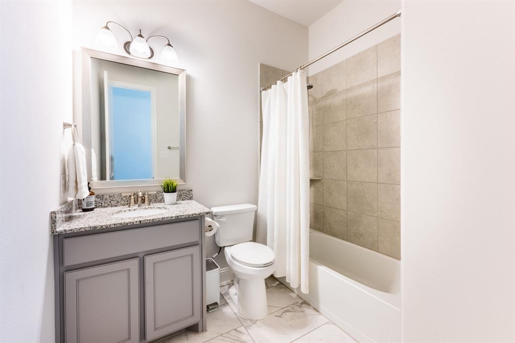 1316 Kirkwood Road Rockwall, TX 75087 - Photo 26 of 37 a bathroom with a sink a toilet and shower