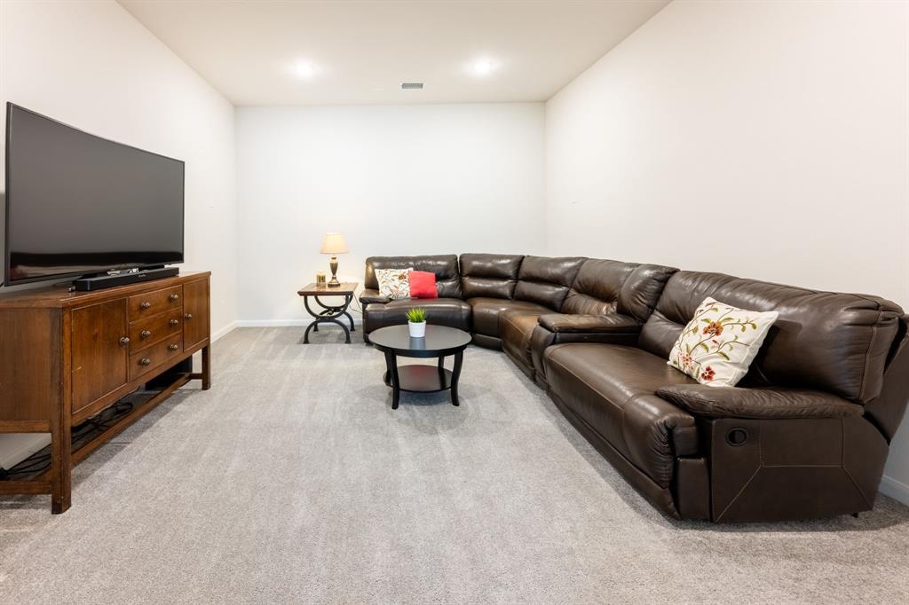 1316 Kirkwood Road Rockwall, TX 75087 - Photo 29 of 37 a living room with furniture and a flat screen tv
