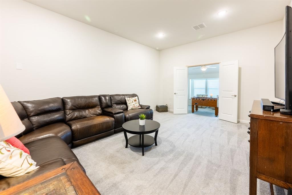 1316 Kirkwood Road Rockwall, TX 75087 - Photo 30 of 37 a living room with furniture and a flat screen tv