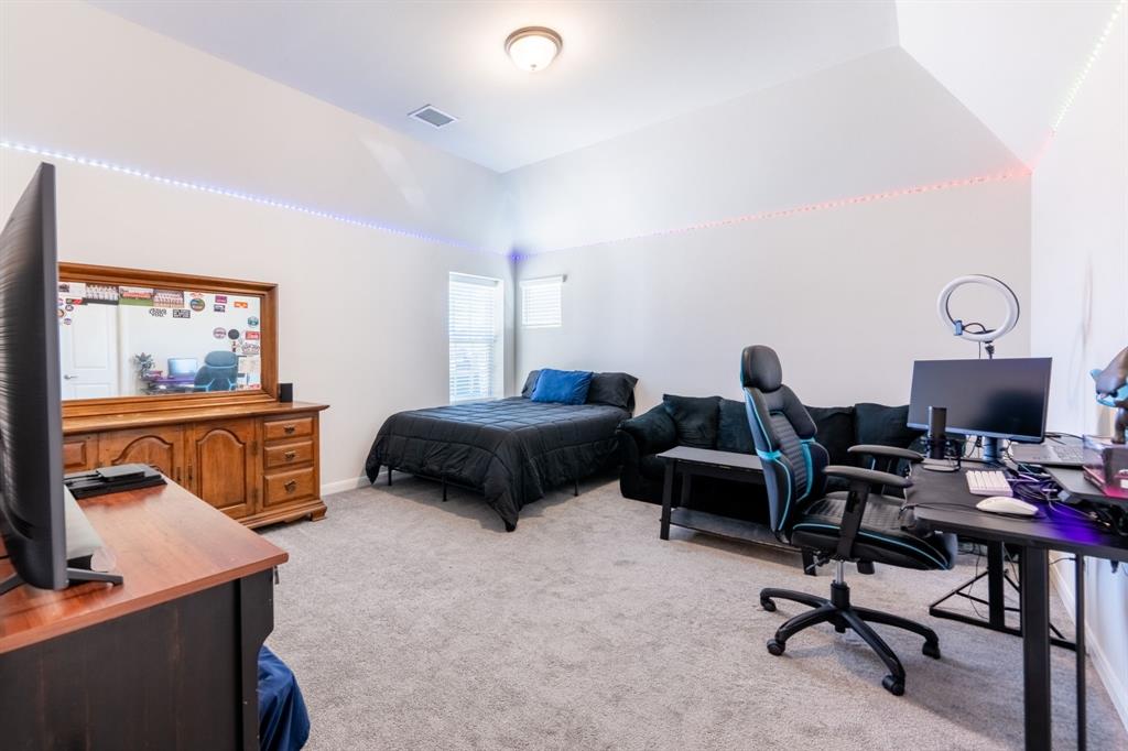 1316 Kirkwood Road Rockwall, TX 75087 - Photo 31 of 37 a bedroom with furniture and a flat screen tv