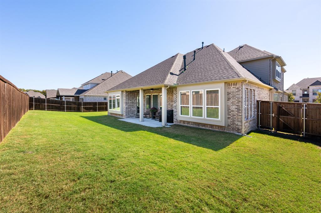 1316 Kirkwood Road Rockwall, TX 75087 - Photo 33 of 37 a view of a house with a big yard and large trees