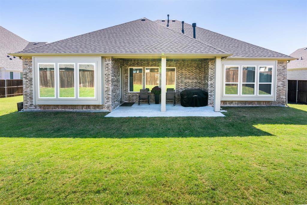 1316 Kirkwood Road Rockwall, TX 75087 - Photo 34 of 37 a front view of a house with yard and glass windows