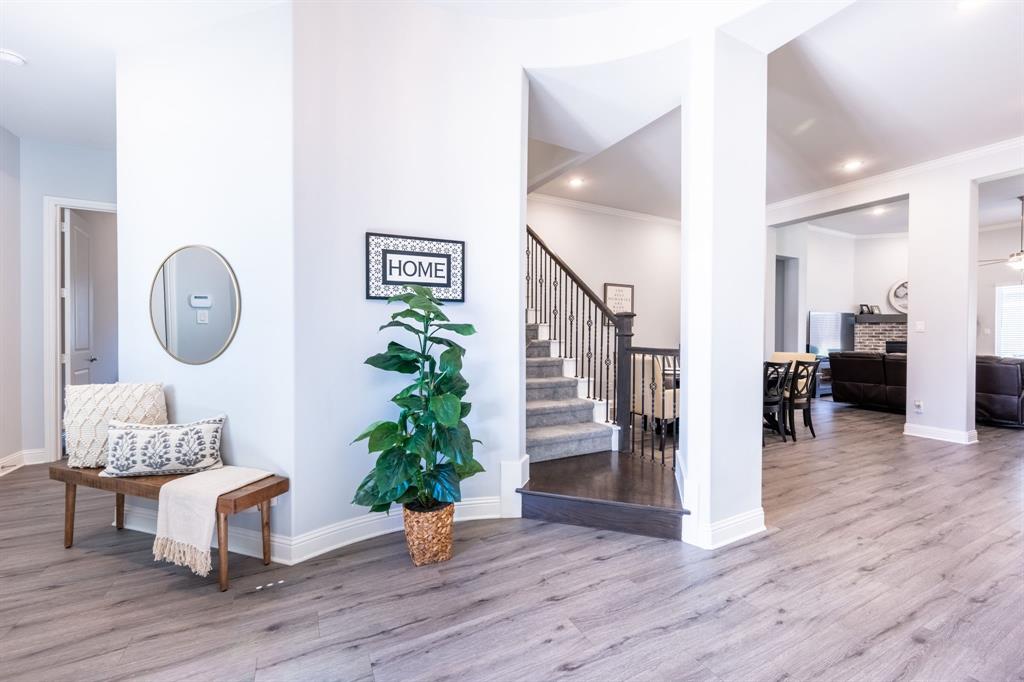 1316 Kirkwood Road Rockwall, TX 75087 - Photo 5 of 37 a view of a hallway with wooden floor table and chairs