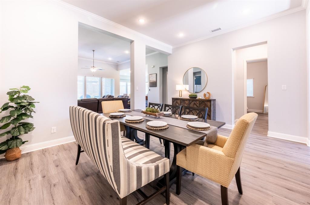 1316 Kirkwood Road Rockwall, TX 75087 - Photo 7 of 37 a dining room with furniture and wooden floor