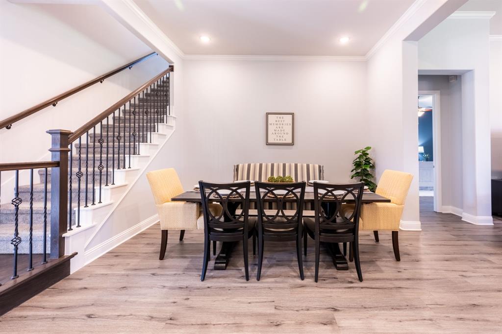 1316 Kirkwood Road Rockwall, TX 75087 - Photo 8 of 37 a view of a dining room with furniture and wooden floor