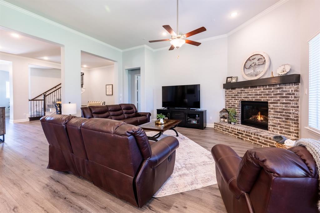 1316 Kirkwood Road Rockwall, TX 75087 - Photo 10 of 37 a living room with furniture a fireplace and a flat screen tv