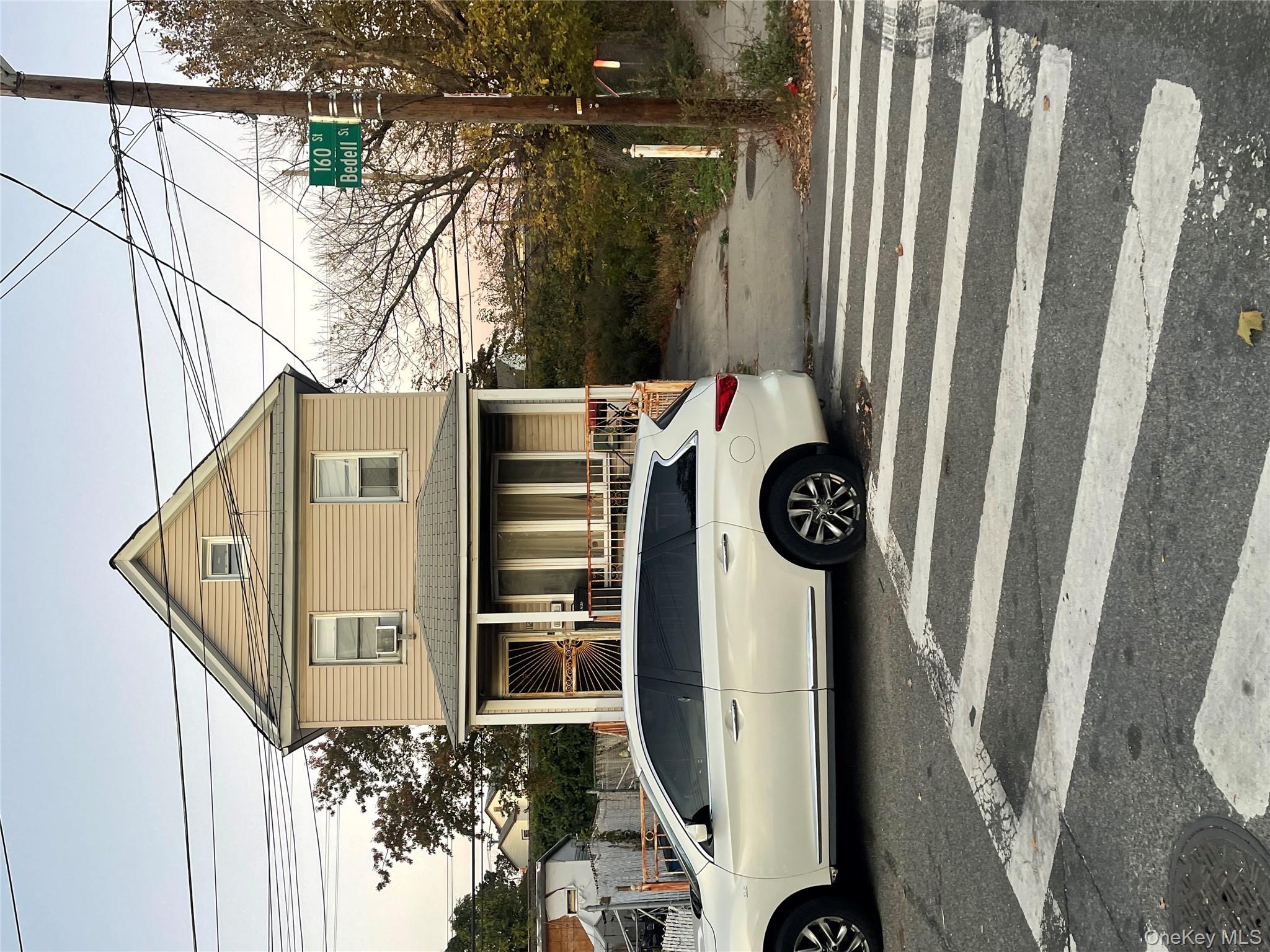 a front view of a house with a parking space